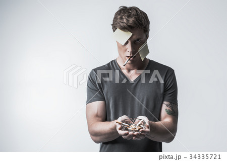 Angry man smoking to spite society 34335721
