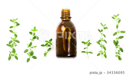 Bottle of essential oil with herbs thyme isolated 34336095