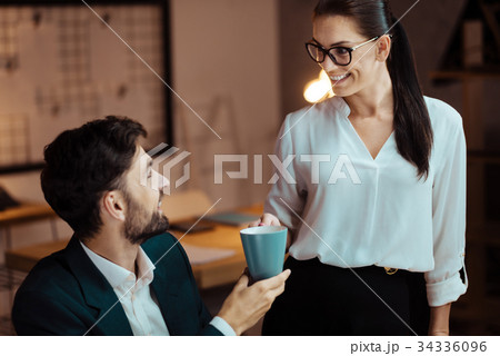Joyful colleagues talking to each other Joyful colleagues talking to each other 34336096