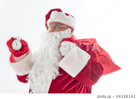 Serious Santa Claus showing time on clock Serious Santa Claus showing time on clock 34336141