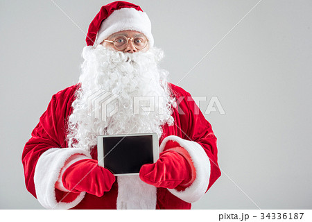 Generous Father Frost showing modern gadget Generous Father Frost showing modern gadget 34336187