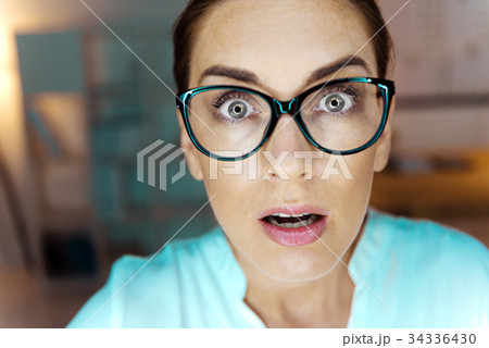 Surprised woman keeping eyes wide opened Surprised woman keeping eyes wide opened 34336430