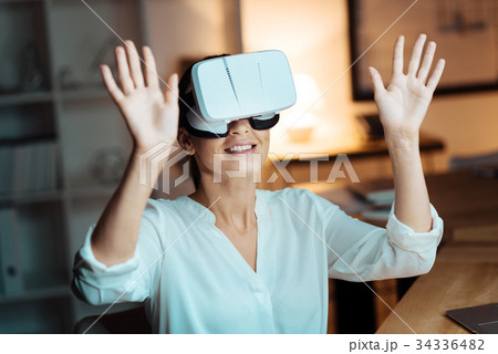 Joyful woman raising her both arms 34336482