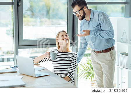 Cheerful office workers socializing during a break 34336495