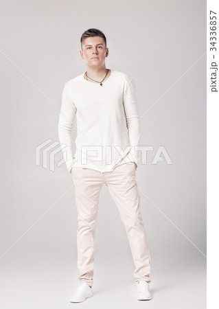 handsome young man in a white sweater and pants  34336857