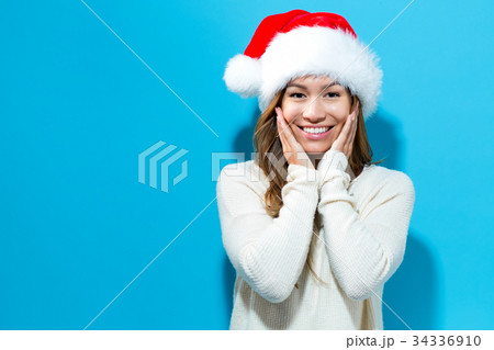 Happy young woman with Santa hat  34336910