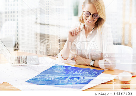 Smiling designer working at the table 34337258