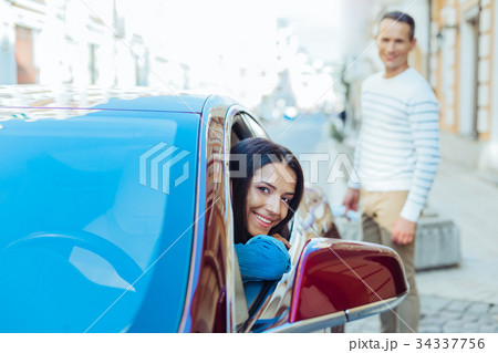 Delighted positive woman looking out of the car 34337756
