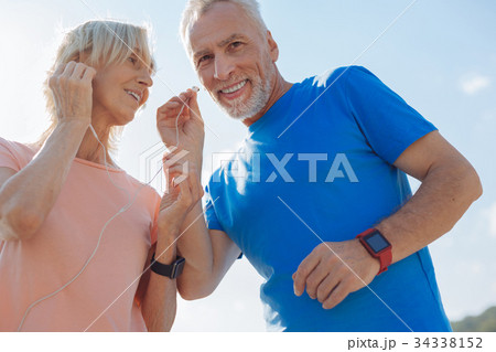 Elderly couple listening to music in one pair of Elderly couple listening to music in one pair of 34338152