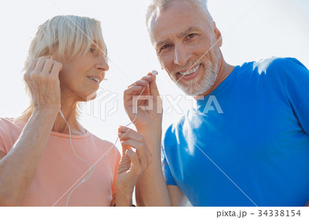 Close up of senior couple listening to the music Close up of senior couple listening to the music 34338154