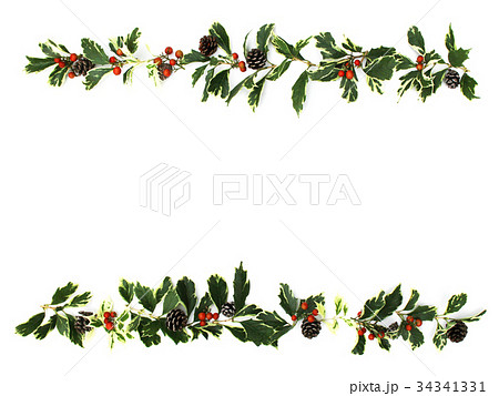 ヒイラギの葉とナンテンの実と松ぼっくりのクリスマスの飾りの写真素材
