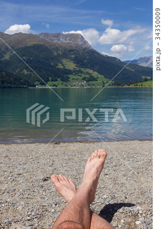 Feet on the beach, relaxing at the Reschensee Feet on the beach, relaxing at the Reschensee 34350009