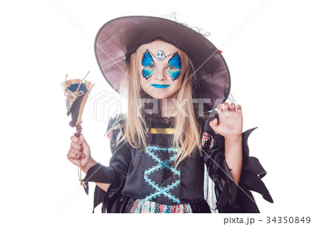 Girl in a witch costume isolated on white 34350849