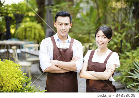 garden restaurant owner standing with partner 34353009