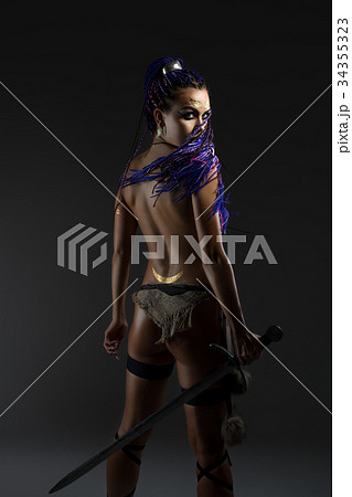 Sexy amazon with dreadlocks and sword rearview 34355323