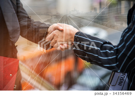 Two business women hand shake at outdoors Two business women hand shake at outdoors 34356469