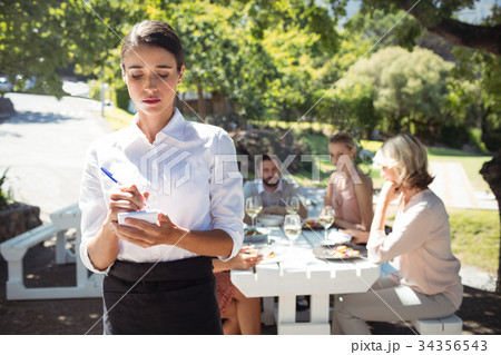 Waitress writing order on notepad Waitress writing order on notepad 34356543