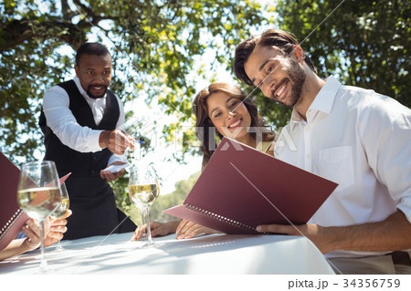 Friends placing order to waiter 34356759