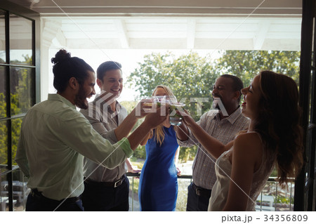 Group of friends toasting cocktail glasses 34356809
