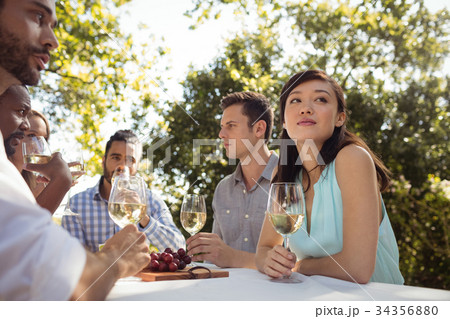 Group of friends interacting with each other while having champagne 34356880