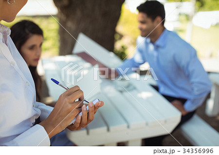 Waitress writing order on notepad 34356996