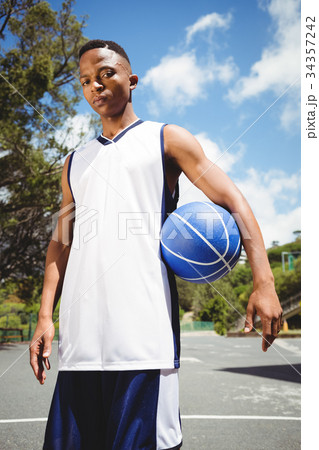 Portrait of male teenager holding ball Portrait of male teenager holding ball 34357242