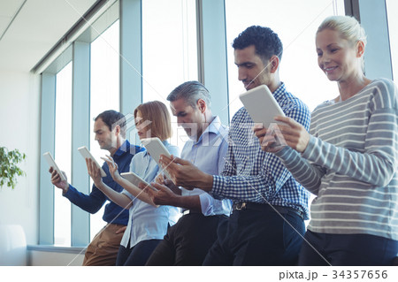 Business colleagues using digital tablets at office 34357656
