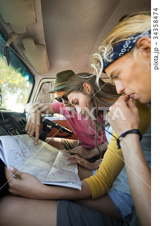 Friends reading map in camper van 34358474