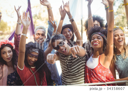Portrait of cheerful friends enjoying during music festival Portrait of cheerful friends enjoying during music festival 34358607