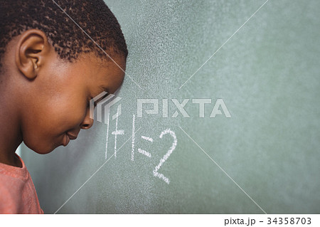 Student leaning on chalkboard 34358703