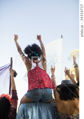 Friends enjoying against sky at music festival 34358737