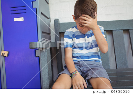 Sad boy sitting on bench 34359016