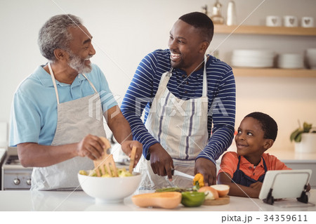 Multi-generation family preparing food in kitchen 34359611