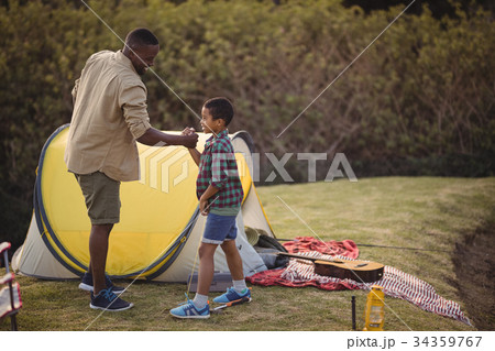 Father and son shaking hands in park Father and son shaking hands in park 34359767