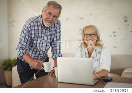 Senior couple using laptop at home Senior couple using laptop at home 34359932