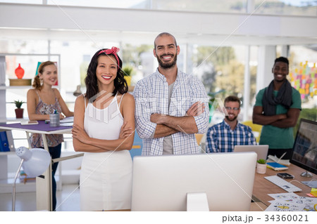 Team of executives standing together in the office Team of executives standing together in the office 34360021
