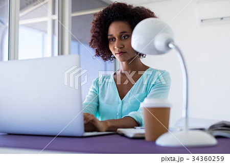 Female executive working over laptop 34360259