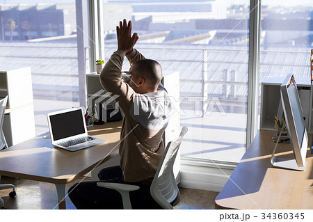 Male executive doing yoga 34360345