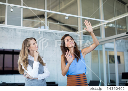 Female executives interacting with each other 34360402
