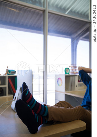 Male executive relaxing at his desk 34360413