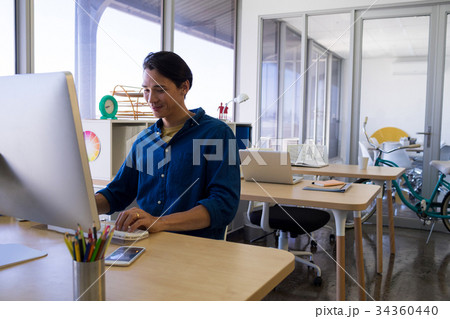 Male executive working over computer at his desk 34360440