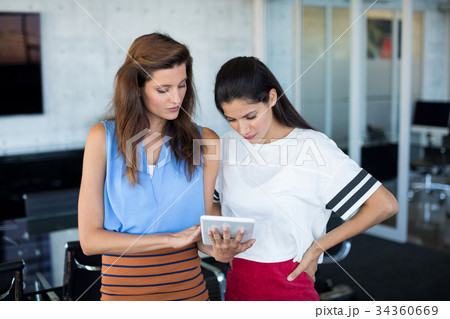 Female executives using digital tablet 34360669