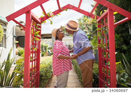 Side view of couple talking in yard 34360697