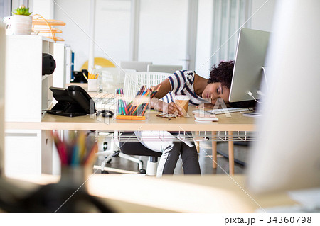 Female executive resting at her desk 34360798
