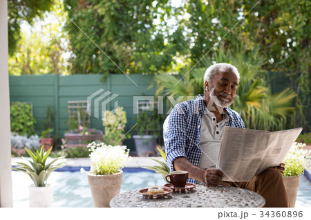 Senior man reading newspaper 34360896