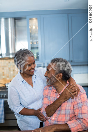 Happy couple talking in kitchen 34360904