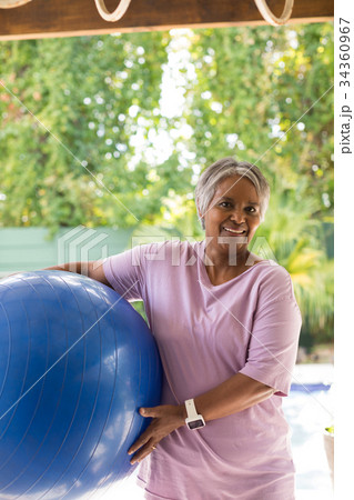 Portrait of smiling woman holding fitness ball 34360967