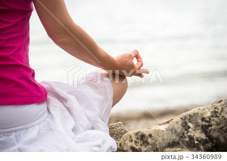 Woman meditating at the lake 34360989