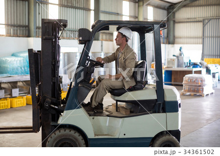 Worker driving forklift 34361502