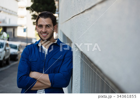 Portrait of smiling young man with arms crossed 34361855